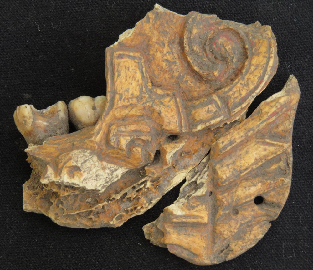 Ancient jewellery made of painted human jawbone found