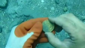 Silver coin found on the sea floor (by AP)