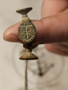 Bronze wheel wax seal recovered from the wreckage (by AP)