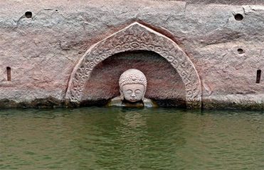 Ancient Buddha statue emerges from water reservoir